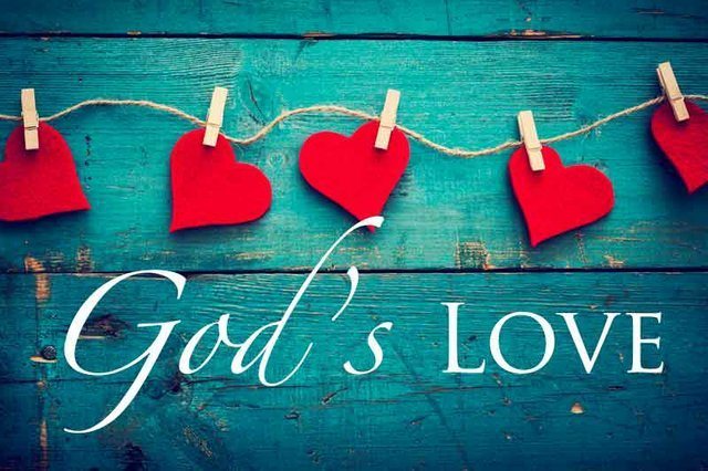 Red paper hearts pegged to a line above the words God’s Love