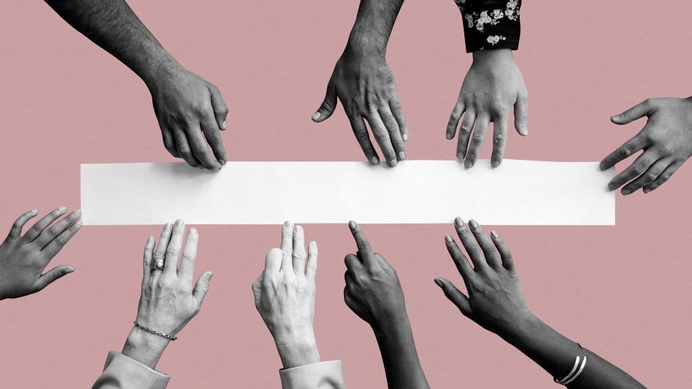 Hands of many different people reaching in from every side