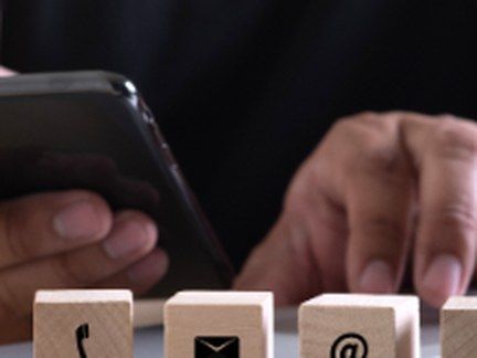 Phone, mail and email icon blocks on a desk