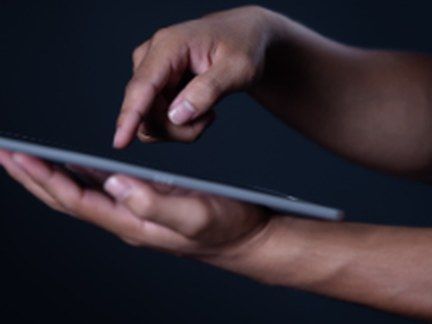 Hands holding a tablet